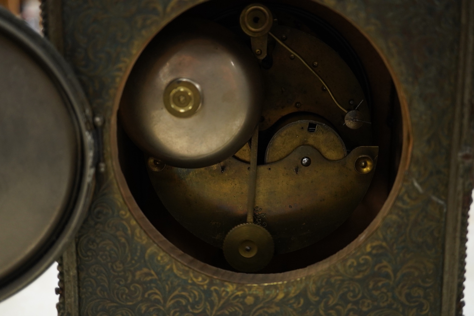 A brass overlaid mantel clock with key and pendulum, striking on a bell, 26cm high